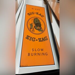 The ZIG-ZAG Man No. 225 Slow Burning Rolling Papers Embossed Metal Sign